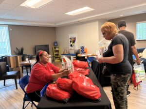 THAW team member with a client at a community assistance event